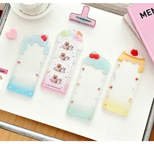 Detail of colorful acrylic photocard holders featuring cute cream drip patterns and icons