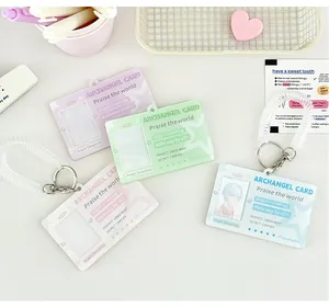 Detail of angel wing acrylic card holders in macaron colors with spring keychain hooks