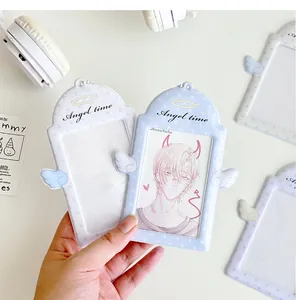 Detail of light blue angel wing PVC photocard holder with Angel Time print and halo