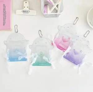 Close-up of glitter acrylic photocard holders with lace ribbons and angel wings