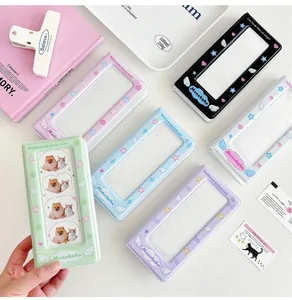 Close-up of pastel PVC mini photo albums with cute heart and angel wing motifs
