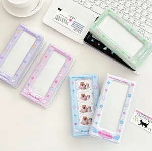 Detail of colorful photo albums with angel wing motifs and transparent cover pockets