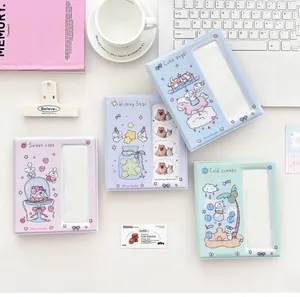 Details of cute cartoon photocard albums in pastel purple, blue, and mint green colors