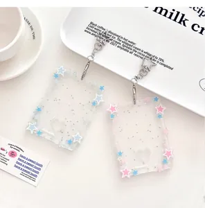 Close-up of heart-shaped glitter acrylic photocard holders with star-shaped metal clasps