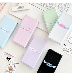 Detailed macro view showing diverse pastel photo albums with cute angel wing graphics