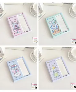 Close-up of four colorful cartoon photo card binders in pink green blue and purple colors