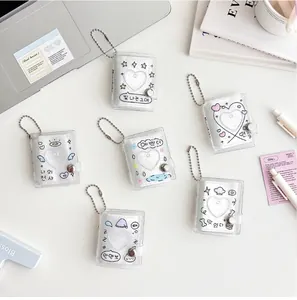 Detailed view of glitter PVC mini photocard albums with cartoon designs and bead chains