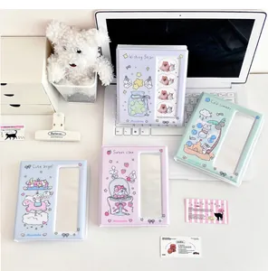 Close-up of colorful cartoon photocard binders in pastel blue, purple and green colors
