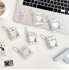 Detail view of 6 glitter PVC mini photo albums with cute Korean style cover illustrations
