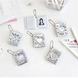 Detailed view of mini photo album with heart-shaped window and metal bead chain