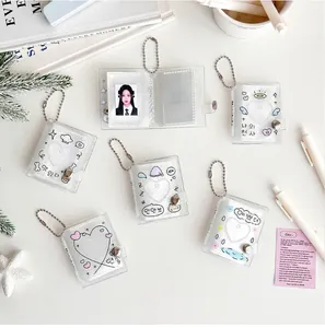 Macro shot of glittery mini photo albums with silver bead chains and heart motifs