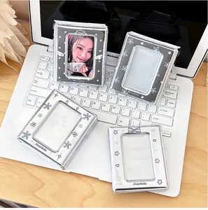 Detail of silver card holders with mirror finish and butterfly patterns on a laptop keyboard