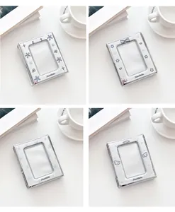 Detail of four silver envelope photo albums with star and angel wing designs