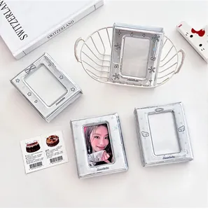 Close-up of silver holographic photocard binder featuring angel wings and star patterns