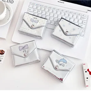 Detail of silver metallic envelope card holders with angel and butterfly prints