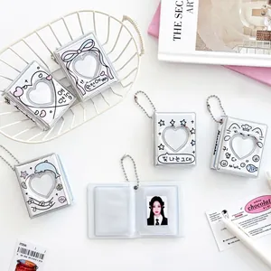 Silver mini photo album keychain with heart cutout and cute charms for kpop photocard storage