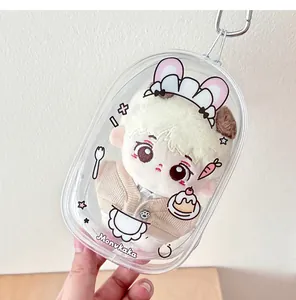 Detail of transparent PVC doll carrier bag with cute plush toy and metal keychain hook