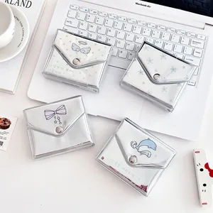 Silver mirror envelope card holders with star and angel prints on white background