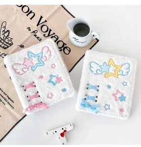 Detail of plush A6 binder with star embroidery and decorative ribbon ties in white