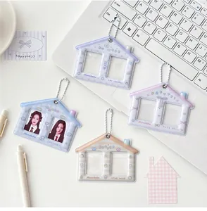 Macro detail of house-shaped double-slot photo card holders with metal ball chains