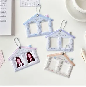 Detail of four colorful house-shaped PVC photo card holders with bead chains on a desk