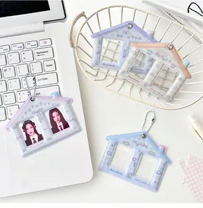 Close-up of house-shaped card holders with dual transparent slots and metal chains