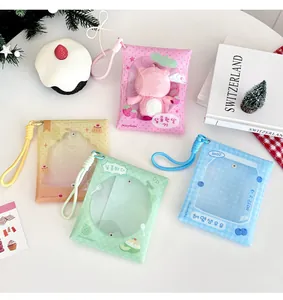 Close-up of colorful clear PVC doll storage bags with lanyards and cute strawberry motifs