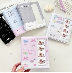 Close-up of 3-inch photo binders in five colors with clear window and metal rings