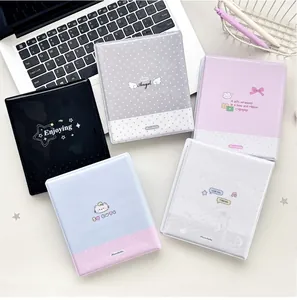 Flat lay view of five mini polka dot photocard albums in various pastel colors