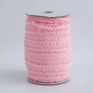 Nastro elastico rosa 1,5cm con bordo a corona su rocchetto per decorazione bambole