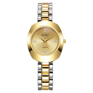 Macro view of minimalist diamond dial with gold and silver link strap watch
