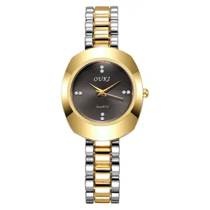 Detail of OUKI women's quartz watch showing rose gold-tone oval case and diamond markers