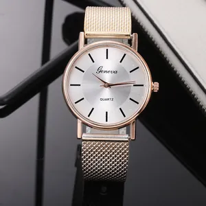 Détail de montre quartz avec bracelet en maille or rose et cadran argenté au design épuré