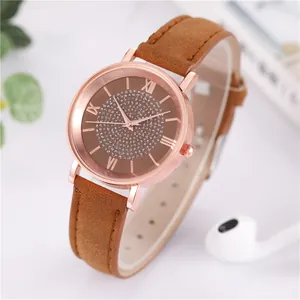 Elegant rose gold watch with sparkling brown dial and leather strap in lifestyle setting