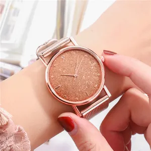 Primer plano de reloj de cuarzo oro rosa con esfera estrellada y correa de malla