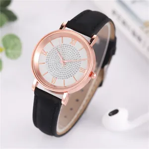 Detail of rose gold watch with sparkling rhinestone spiral dial and black leather strap