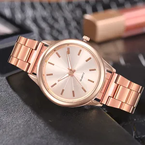 Detail view of rose gold quartz watch with minimalist metal indices and triple-link band