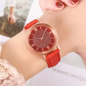 Close-up of red leather strap watch with rose gold diamond dial on woman's wrist