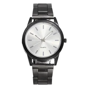Detail of minimalist black quartz watch featuring a silver sunray dial and metal band