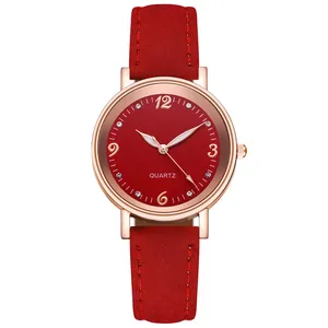 Detailed close-up of a red textured quartz watch dial with rose gold case and rhinestones