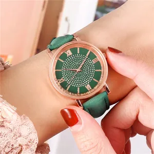 Close-up of green dial watch with rose gold case and crystal starburst design