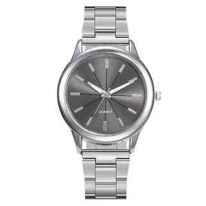 Macro detail of minimalist quartz watch with dark grey sunburst dial and silver steel band