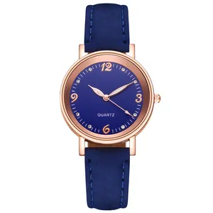 Close-up of navy blue matte strap and rose gold quartz watch case with rhinestones