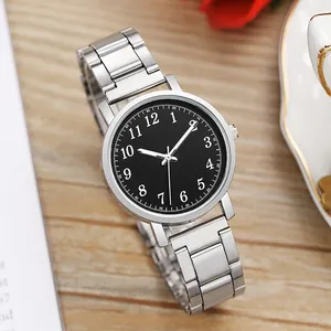 Classic silver steel watch with black numeric dial on an aesthetic wooden surface