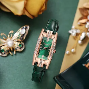 Detailed macro view of rectangular rose gold watch with crystals and green sunray dial