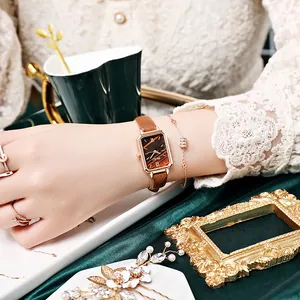 Detail of vintage square quartz watch with brown leather strap and rose gold metal case