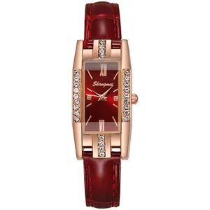 Detailed macro view of the rose gold rectangular watch case with shimmering diamond accents