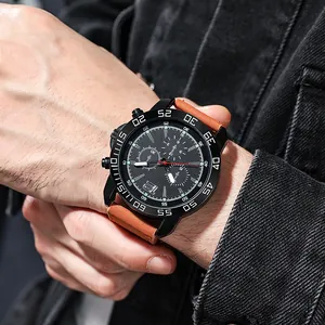 Close-up of men's quartz watch with black dial and brown leather strap on wrist