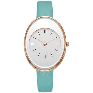 Detail view of oval rose gold quartz watch with minimalist dial and mint green leather strap