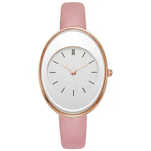 Detail of pink leather strap and rose gold oval watch case with white minimalist dial